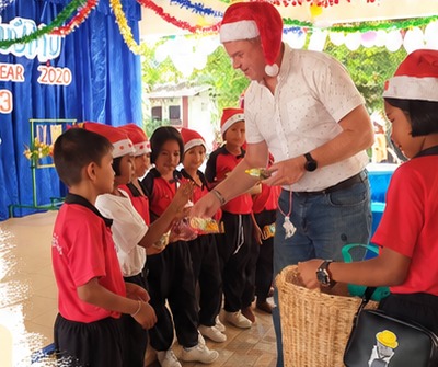Handing out Christmas presents to children at a village school
