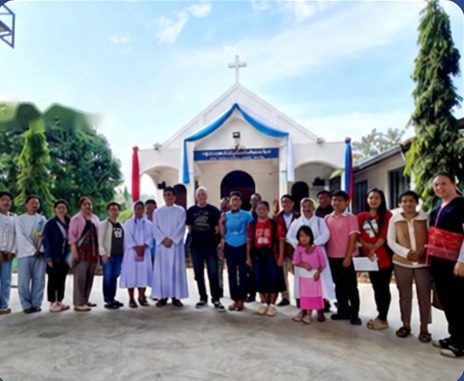 Villagers, sisters and friends gathered in front of a village church in Thailand