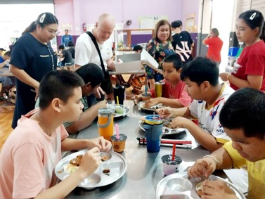 Serving a hot lunch to schoolchildren